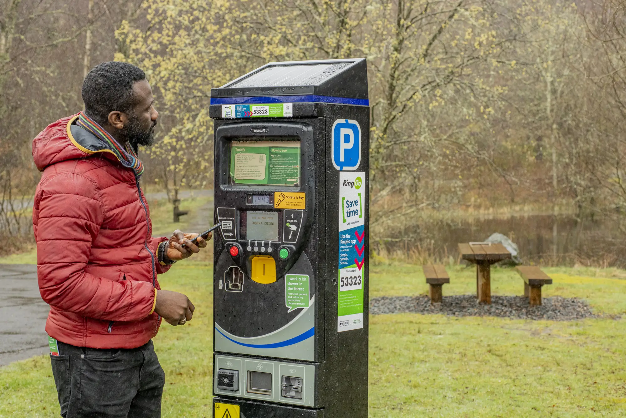 Man paying at parking meter