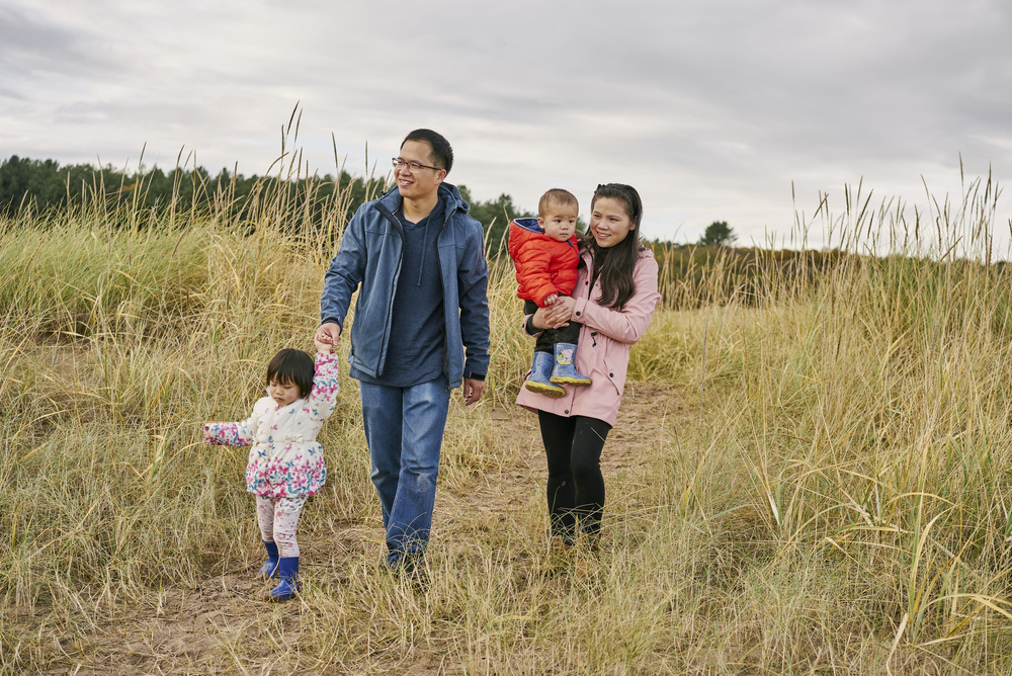 Young family walking at Tentsmuir beach