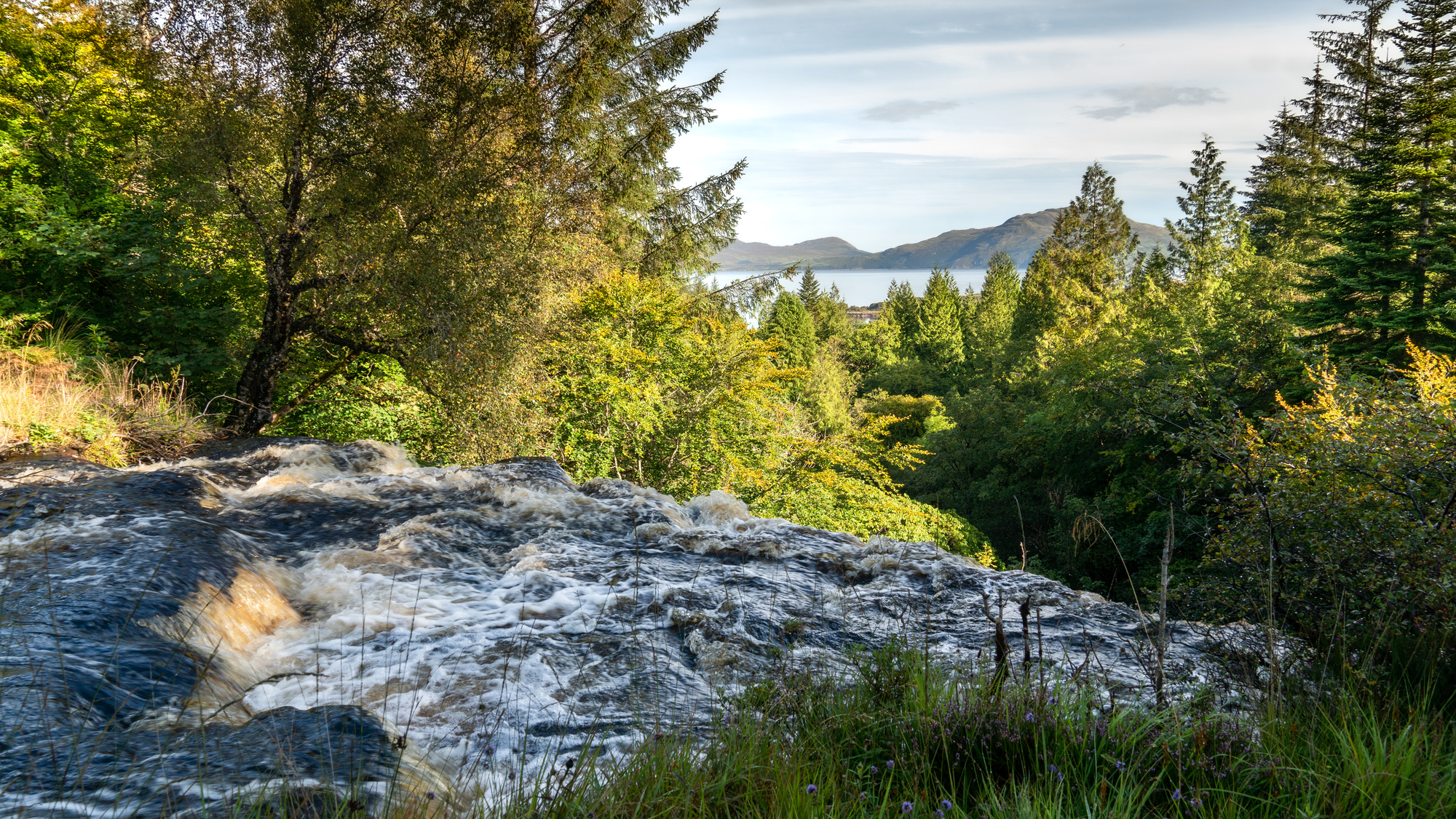  The top of a waterfall overlooking the sea and forest