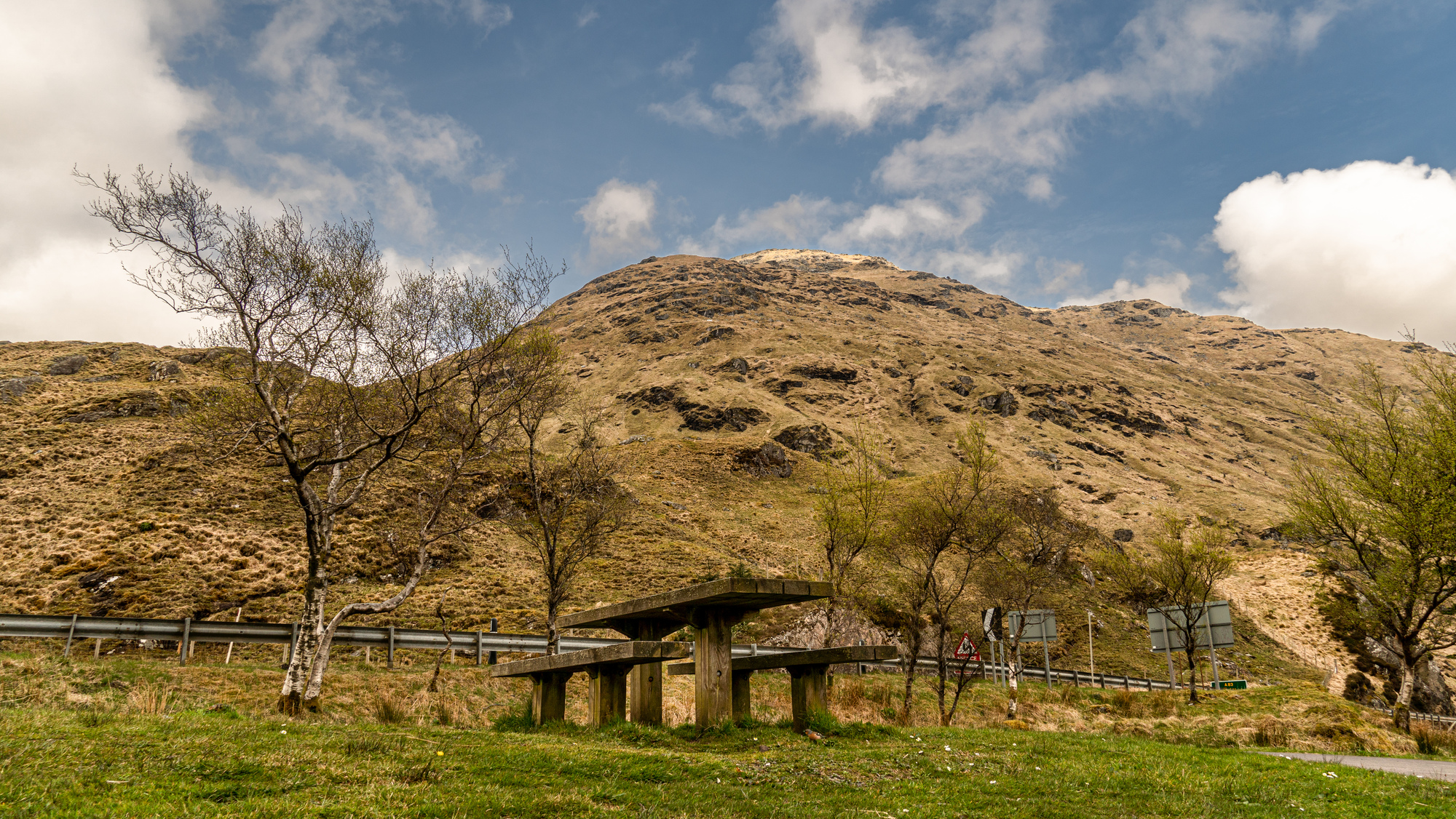 A picnic table besides a hill