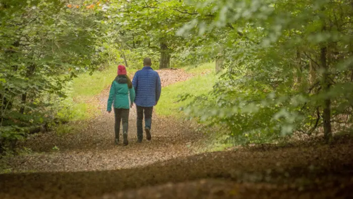 Two people walking along a path.