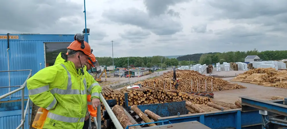 A man in safety gear at a sawmill