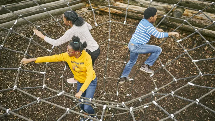 Aerial view of three children playing in funnel trap at play area in Cuningar Loop Woodland Park, Glasgow
