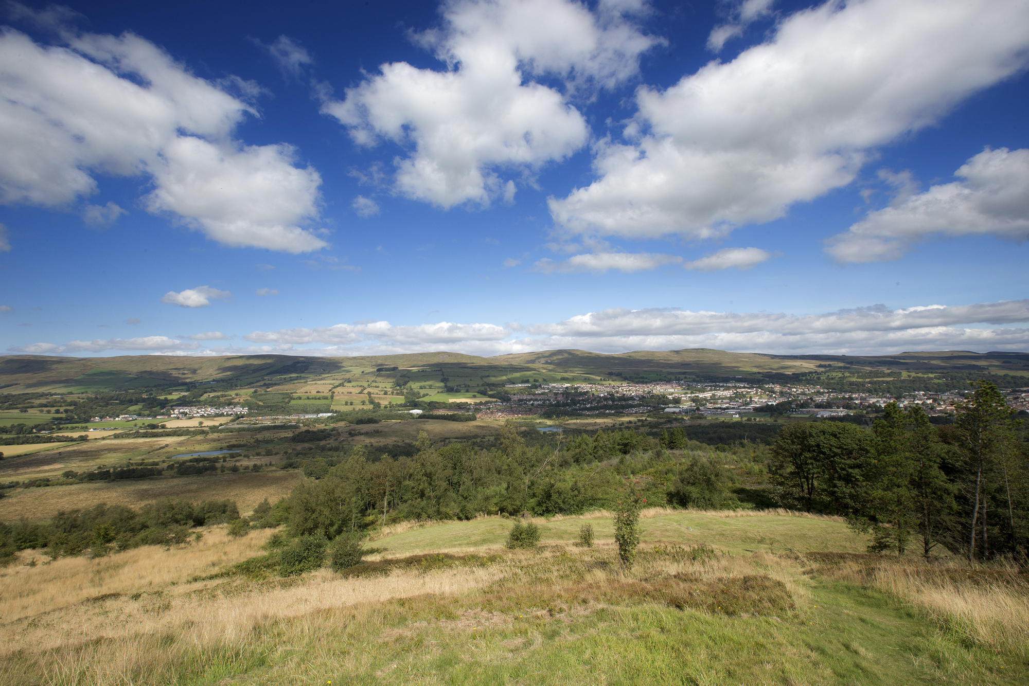  A view of a valley and village from the top of a hill