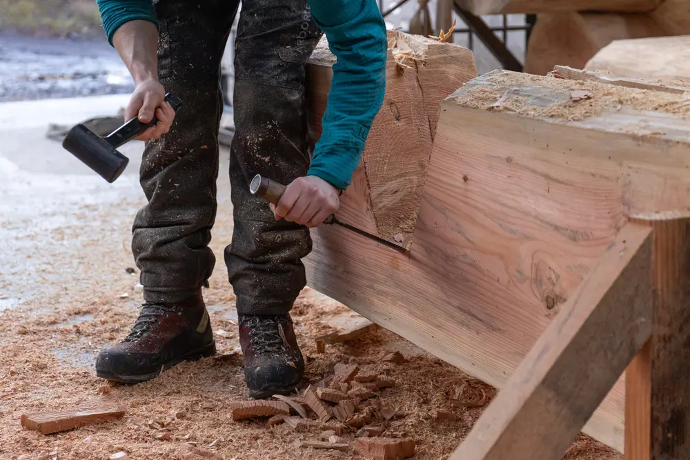 A staff member carving out a log