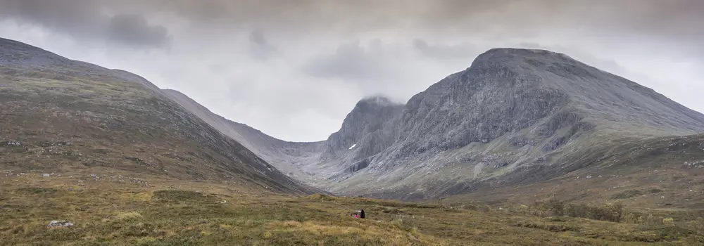 View up valley to forbidding grey cliffs of Ben Nevis