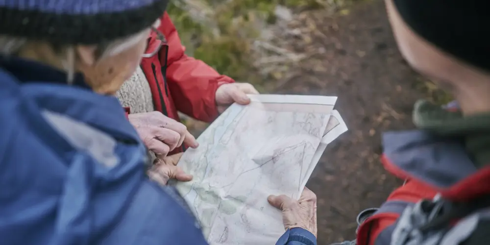 A close-up shot of three people looking at a map